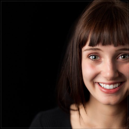 Blog girl smiling on black london studio