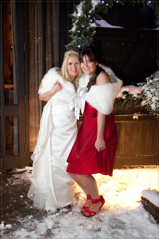Nikki with her bridesmaid, winter wedding portrait by Mat Smith Photography outside the Tithe Barn, Hurley