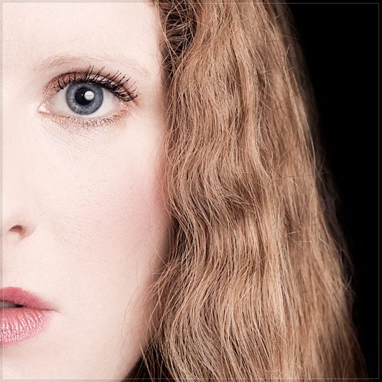 Cheryl Frances-Hoad, composer, close-up headshot on black by Mat Smith Photography, Cambridge