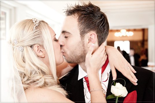 Nikki and Tom kiss after the ceremony in the Tithe Barn, Ye Olde Bell, Hurley