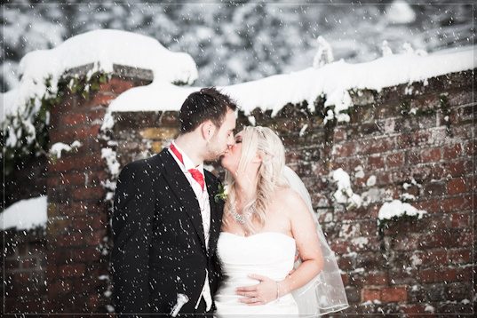 Nikki and Tom kiss in the snow outside Ye Olde Bell, Hurley