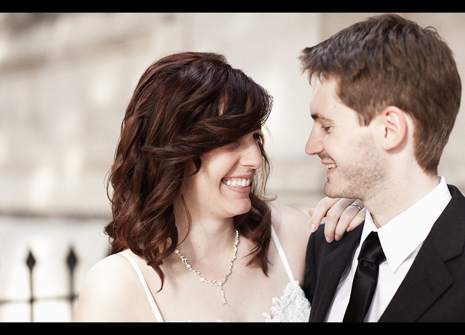 Wedding couple smiling by a church, Regent's Park, London
