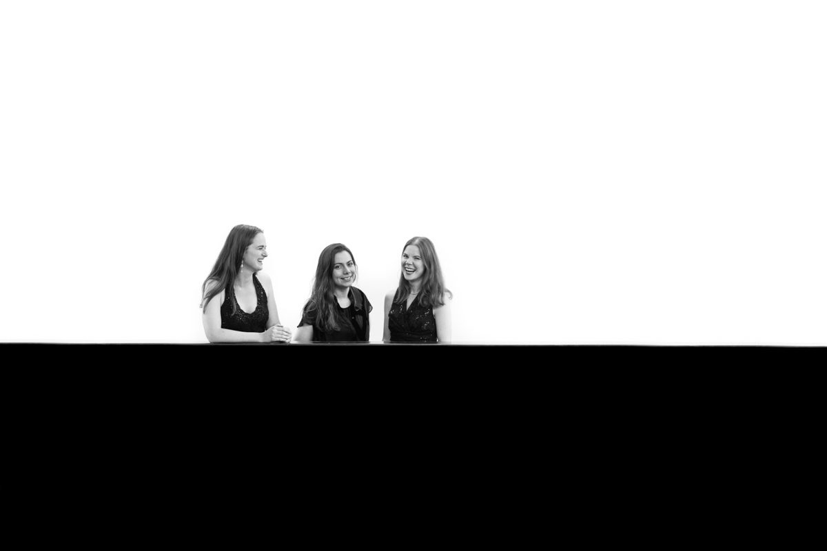 Lawson Trio laughing by the escalator, black and white portrait by Mat Smith Photography, Tate Modern