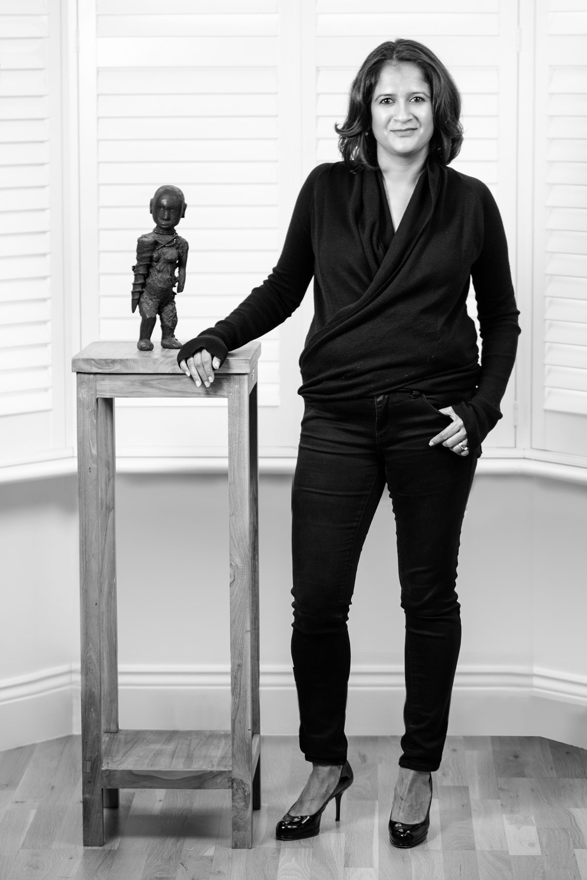 Toto James, marketing consultant and Woman of the Year nominee, with a statue, portrait by Mat Smith Photography