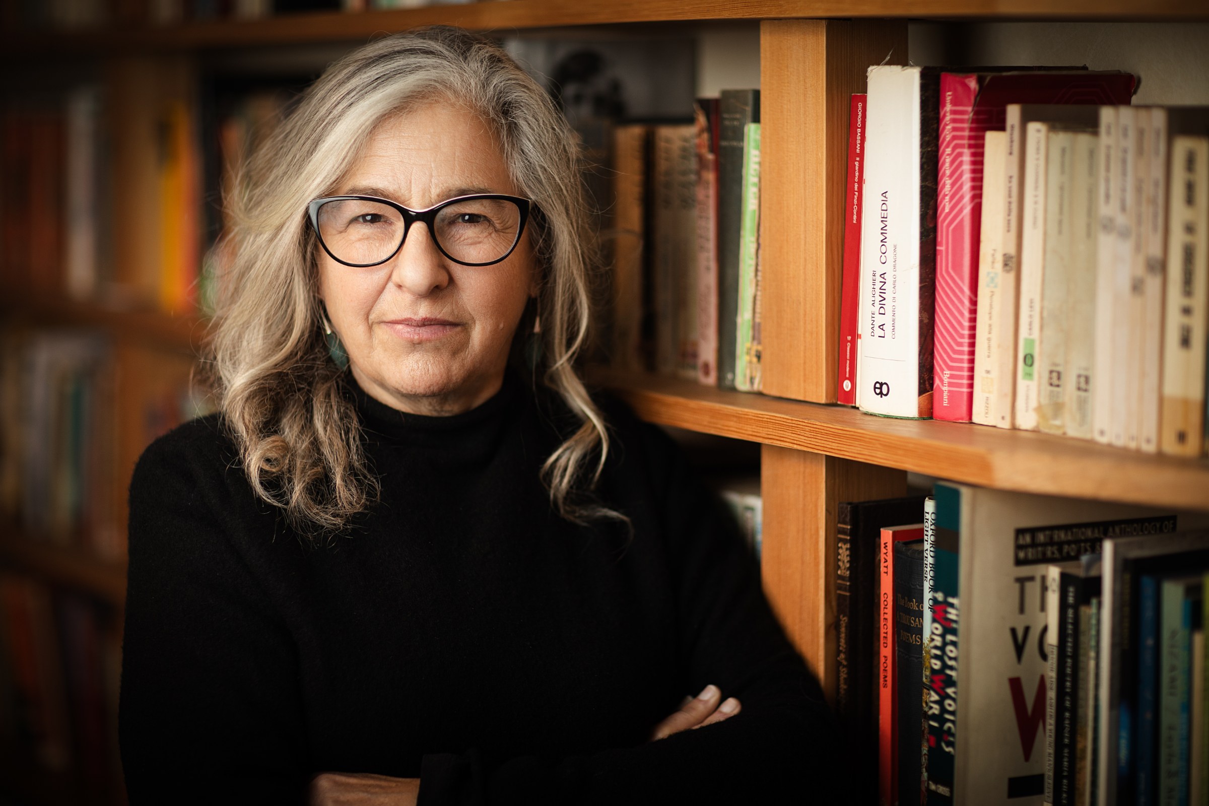 Karen Liebreich MBE, author and historian, standing in the library, colour portrait by Mat Smith Photography, Chiswick