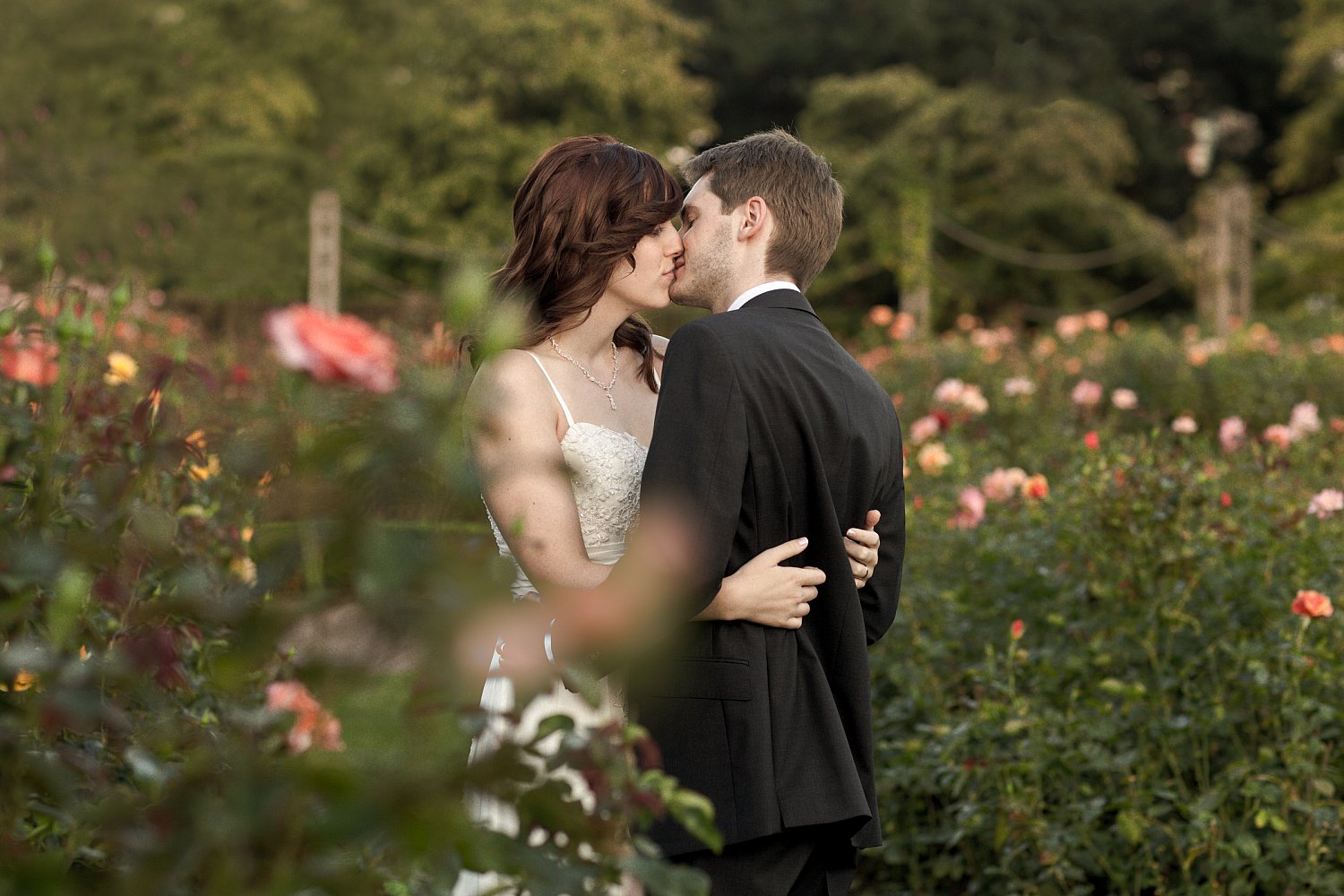 Jamie and Thomas embracing in the Rose Garden, couple portrait by Mat Smith Photography, Regent's Park, London
