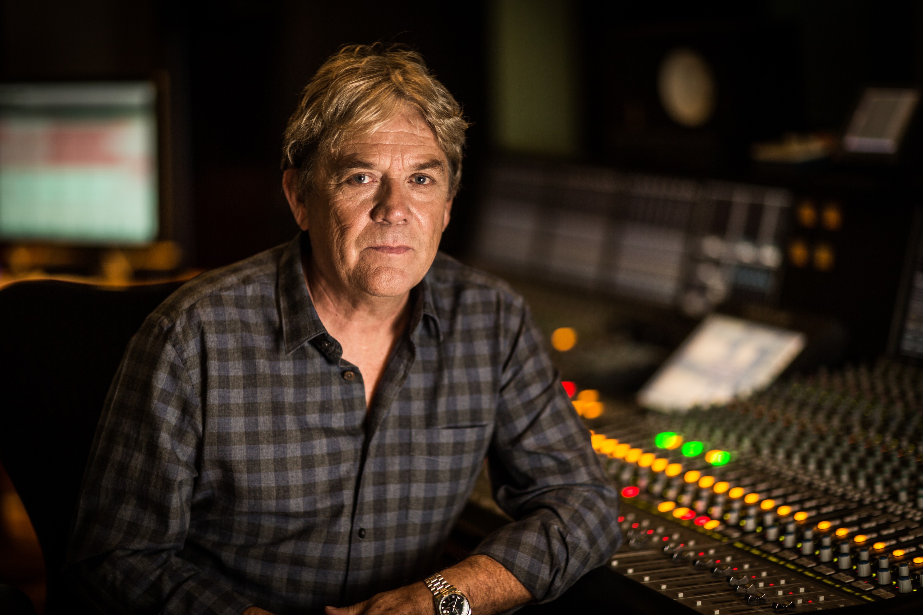 Mike Stock, songwriter and producer, seated at a mixing desk, portrait by Mat Smith Photography