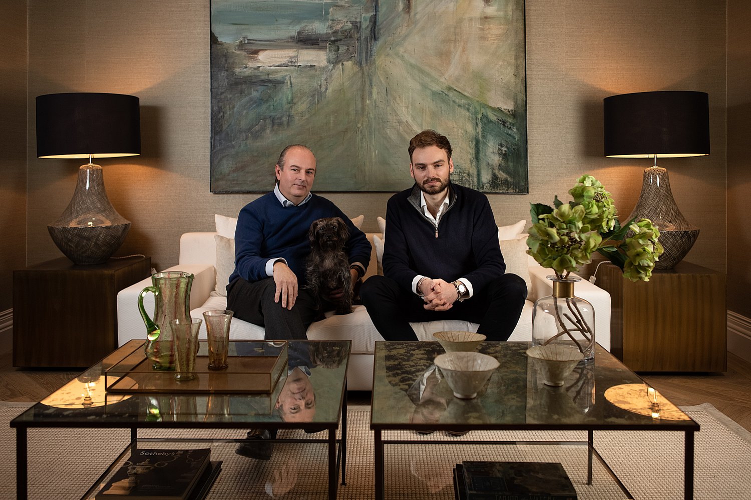 Father, son and dog in a symmetrical London townhouse interior