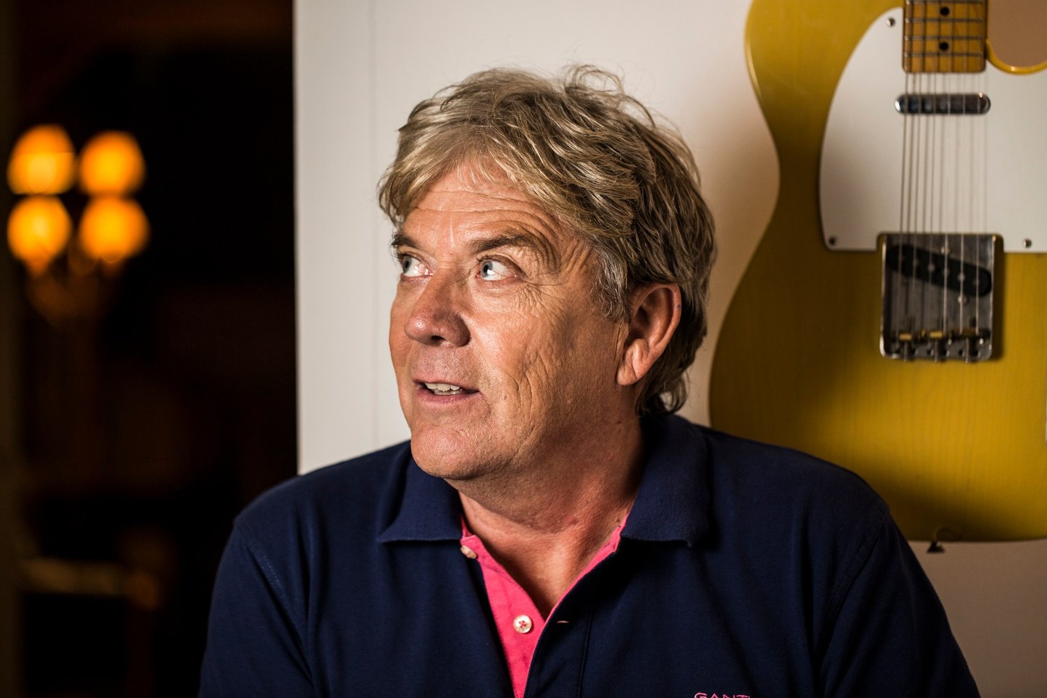 Mike Stock, songwriter and producer, beside a yellow Telecaster on the wall, portrait by Mat Smith Photography
