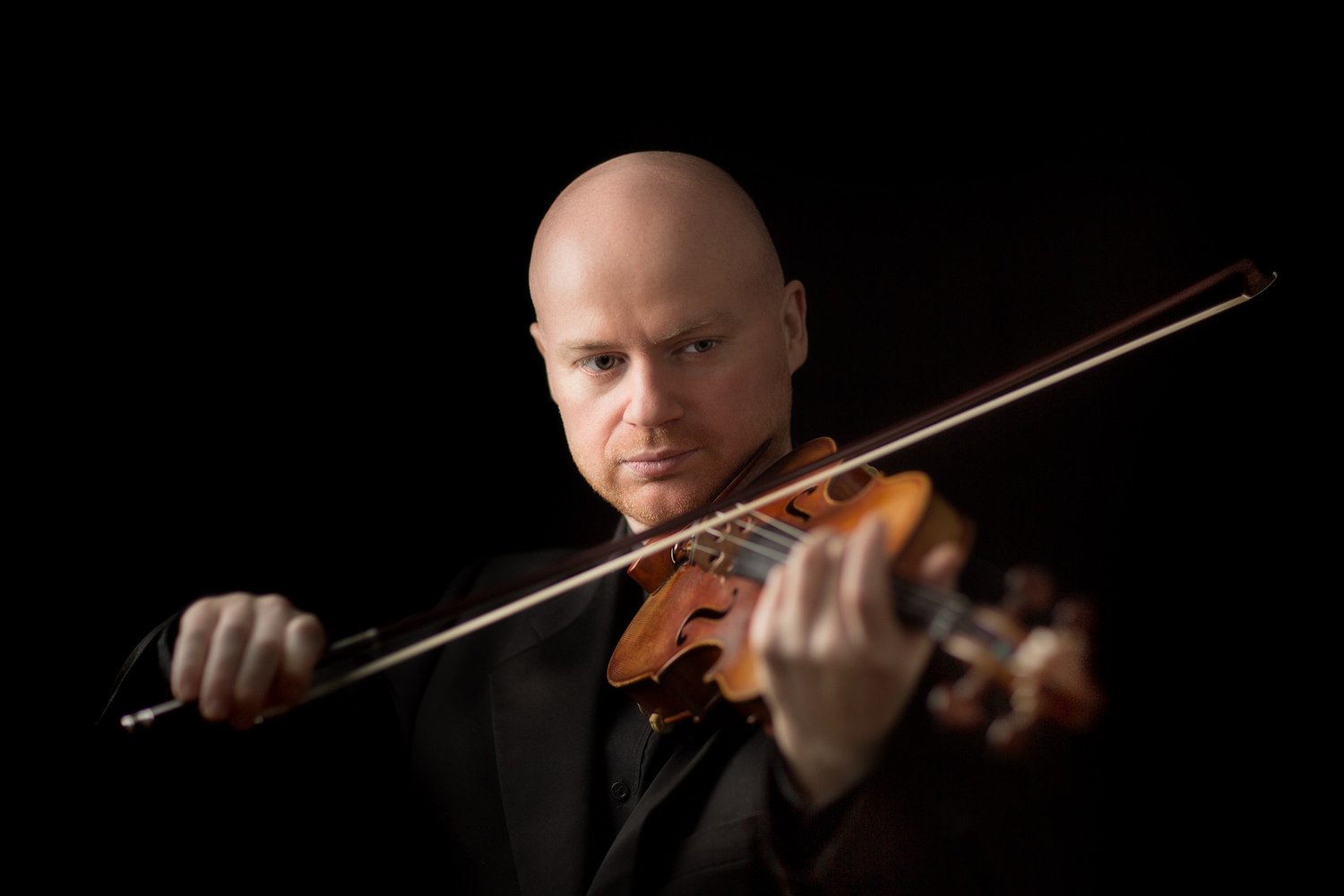 Violinist playing in a dark jacket against a black background, from the Savage and Spies session, portrait by Mat Smith Photography