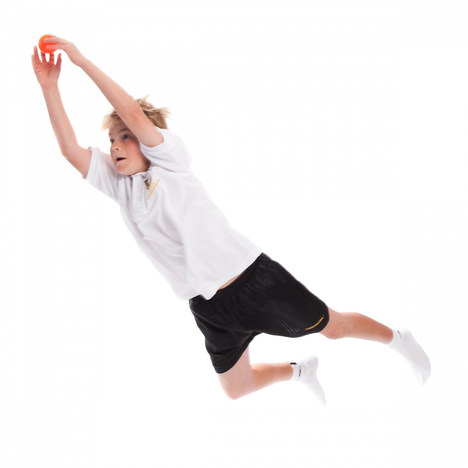 Boy leaping for the ball in a school athletics lesson