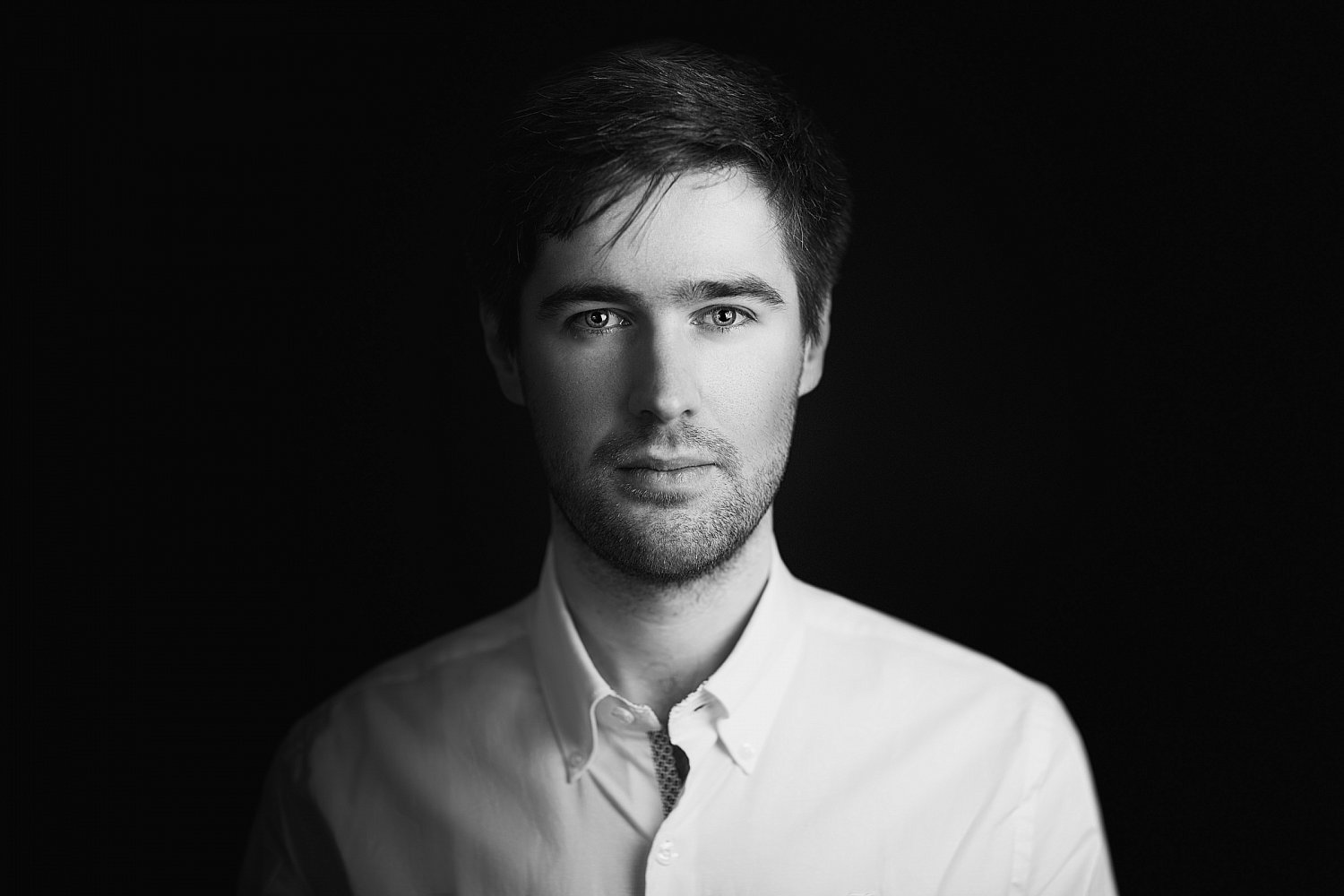 Moody black and white portrait in deep shadow