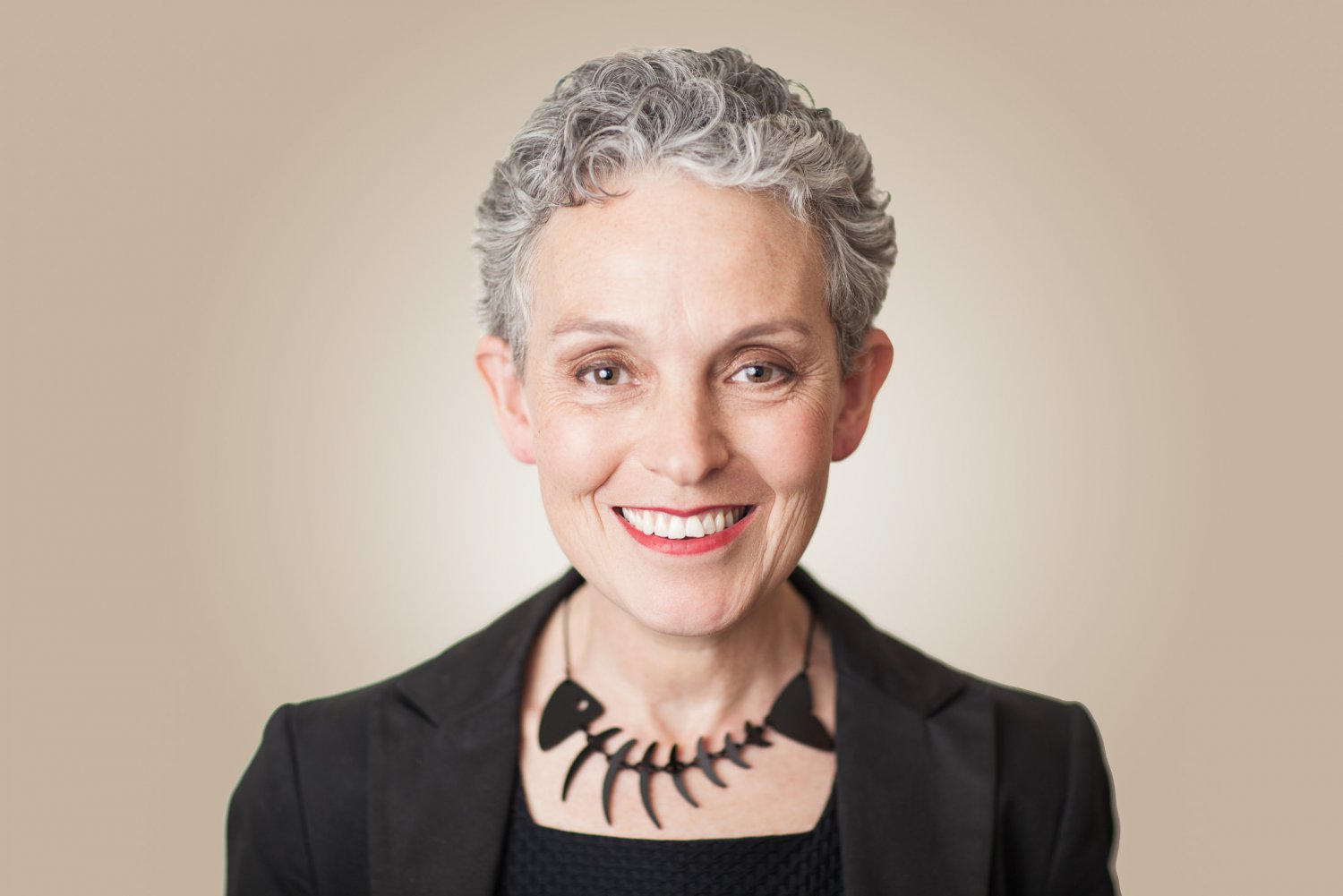 Sally Macdonald, museum director, colourful portrait by Mat Smith Photography in East London